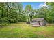 Wide angle shot of home on large lot with deck, shed, and mature trees at 1786 Richard Ne Rd, Conyers, GA 30012