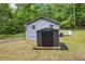 View of the home's backyard with an outdoor shed for extra storage and a quaint deck area at 1786 Richard Ne Rd, Conyers, GA 30012