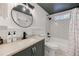 Cozy bathroom featuring subway tile, a vanity, and a shower-tub combo at 1786 Richard Ne Rd, Conyers, GA 30012