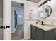Modern bathroom features a gray vanity with a round mirror and stylish lighting at 1786 Richard Ne Rd, Conyers, GA 30012