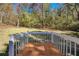 Exterior wooden deck with white railing overlooking grassy lawn with trees at 1786 Richard Ne Rd, Conyers, GA 30012