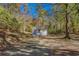 Exterior front of light blue cottage with white trim, inviting porch and mature trees at 1786 Richard Ne Rd, Conyers, GA 30012