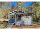 Charming single-story home featuring a cozy front porch and a well-maintained, wooded front yard at 1786 Richard Ne Rd, Conyers, GA 30012