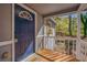 Inviting front porch with a stylish blue door and a natural wood deck at 1786 Richard Ne Rd, Conyers, GA 30012