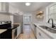 Bright kitchen featuring wooden shelves, stainless steel appliances, and ample counter space at 1786 Richard Ne Rd, Conyers, GA 30012