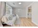 Inviting living room featuring hardwood floors, natural light, a couch, and stylish decor at 1786 Richard Ne Rd, Conyers, GA 30012