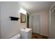Bathroom with single vanity, large mirror, toilet, and storage at 2002 Fairbrook Ln, Woodstock, GA 30189