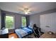 Cozy bedroom features hardwood floors, natural light, a ceiling fan, and closet at 2002 Fairbrook Ln, Woodstock, GA 30189