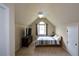 Spacious bedroom with vaulted ceiling, ceiling fan, window, and a television on a dresser at 2002 Fairbrook Ln, Woodstock, GA 30189