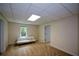 The carpeted bedroom features a window, sofa, and access to a closet and another room at 2002 Fairbrook Ln, Woodstock, GA 30189