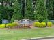 Stone community entrance sign surrounded by manicured landscaping and mature trees at 2002 Fairbrook Ln, Woodstock, GA 30189