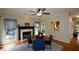 Dining room featuring a decorative fireplace, hardwood floors, and backyard views at 2002 Fairbrook Ln, Woodstock, GA 30189