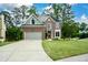 Charming brick home with lush lawn, beautiful landscaping, and a long driveway to the attached two-car garage at 2002 Fairbrook Ln, Woodstock, GA 30189