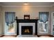 Cozy fireplace with decorative mantel and plenty of natural light at 2002 Fairbrook Ln, Woodstock, GA 30189