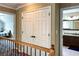 Upstairs hallway featuring a laundry closet, with a view into a bathroom and bedroom at 2002 Fairbrook Ln, Woodstock, GA 30189