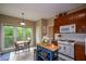 Cozy kitchen featuring stainless appliances, and bright natural light from large windows at 2002 Fairbrook Ln, Woodstock, GA 30189