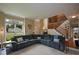 Bright living room with carpeted floors, staircase, and large sectional sofa at 2002 Fairbrook Ln, Woodstock, GA 30189