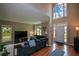 Bright living room with hardwood floors, a soaring two-story window, and an open floorplan at 2002 Fairbrook Ln, Woodstock, GA 30189