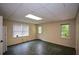 This living room features tile flooring, neutral walls, and access to the outside at 2002 Fairbrook Ln, Woodstock, GA 30189