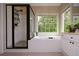 Spa-like bathroom with large tub, glass shower, and double vanity at 2002 Fairbrook Ln, Woodstock, GA 30189