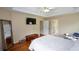 Large main bedroom with hardwood floors, seating, a TV, and tray ceiling at 2002 Fairbrook Ln, Woodstock, GA 30189