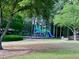 Community playground featuring colorful play structures, swings, and a basketball court at 2002 Fairbrook Ln, Woodstock, GA 30189