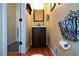 Compact powder room with wood floors, vanity with storage, and decorative accents at 2002 Fairbrook Ln, Woodstock, GA 30189