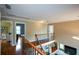 Second floor hallway overlooking the living area with wooden floors and neutral paint at 2002 Fairbrook Ln, Woodstock, GA 30189