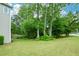 Expansive green yard with mature trees offering shade and privacy at 2002 Fairbrook Ln, Woodstock, GA 30189