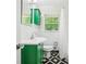 Bathroom featuring striking green vanity and black and white geometric tile floor at 2381 Woodacres Ne Rd, Atlanta, GA 30345