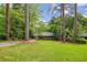 Charming home with a manicured lawn, mature trees, and a long driveway at 2381 Woodacres Ne Rd, Atlanta, GA 30345