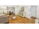 Open-concept living room with hardwood floors, stylish furniture, and seamless flow to the dining area at 2381 Woodacres Ne Rd, Atlanta, GA 30345