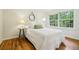 Cozy bedroom with hardwood floors and natural light from a large window at 2381 Woodacres Rd, Atlanta, GA 30345