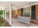 Charming front porch with a porch swing and classic columns at 2381 Woodacres Rd, Atlanta, GA 30345