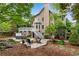 Beautiful backyard featuring a deck, spa, stone patio with fire pit, and lush landscaping at 3106 Soldier Trl, Marietta, GA 30068