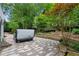 Backyard spa with a stone patio and retaining wall bordering mature landscaping and a natural creek at 3106 Soldier Trl, Marietta, GA 30068