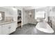Modern bathroom with stand-alone tub, glass shower, and neutral tile at 3106 Soldier Trl, Marietta, GA 30068