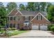 Beautiful brick two-story home featuring a manicured lawn, mature landscaping, and a two-car garage at 3106 Soldier Trl, Marietta, GA 30068