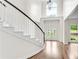 Light filled foyer highlighting hardwood floors, a curved staircase, and a large window at 3106 Soldier Trl, Marietta, GA 30068