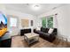 Cozy living room showcasing a leather couch, and bright natural light from windows at 3106 Soldier Trl, Marietta, GA 30068