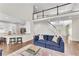 Spacious living room with a blue couch, chess table, and an open view to the kitchen and staircase at 3106 Soldier Trl, Marietta, GA 30068