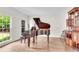 Formal living room featuring a grand piano, hardwood floors, and natural light at 3106 Soldier Trl, Marietta, GA 30068