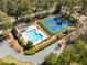 Aerial view of community amenities: pool, tennis courts, and surrounding greenery providing recreation and relaxation at 3358 Stovehill Se Ct, Marietta, GA 30067