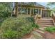 Wooden back deck features an enclosed sunroom, creating an indoor-outdoor living experience with backyard access at 3358 Stovehill Se Ct, Marietta, GA 30067