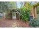 Charming backyard entrance through a wooden gate with climbing vines, surrounded by verdant foliage at 3358 Stovehill Se Ct, Marietta, GA 30067