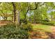 Lush backyard with stone pathway leading to a wooden deck, offering a serene and private outdoor escape at 3358 Stovehill Se Ct, Marietta, GA 30067