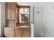 Well lit bathroom with wood cabinets, granite counters, a glass enclosed shower and tiled walls at 3358 Stovehill Se Ct, Marietta, GA 30067