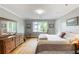 Spacious bedroom with wood floors, neutral walls, a large window and traditional decor at 3358 Stovehill Se Ct, Marietta, GA 30067