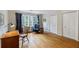 Bedroom with wood floors, dual closets, windows with blue curtains, chair, and desk at 3358 Stovehill Se Ct, Marietta, GA 30067