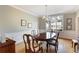Formal dining room with wainscoting, chandelier lighting, and a view of the front yard from the window at 3358 Stovehill Se Ct, Marietta, GA 30067